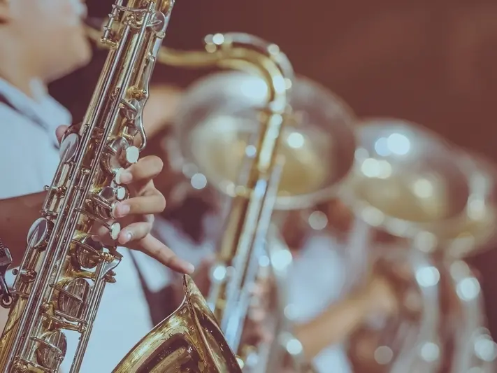 Students playing saxophone and sousaphone